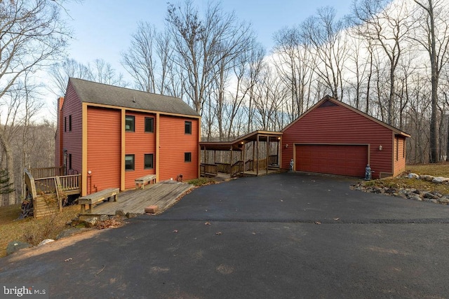 view of side of home with a garage and a deck