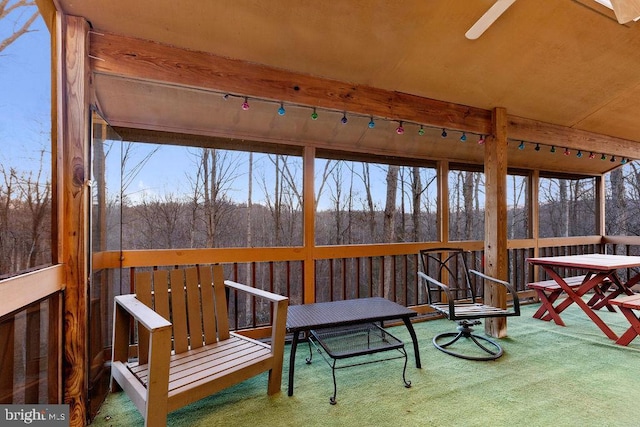 sunroom featuring ceiling fan