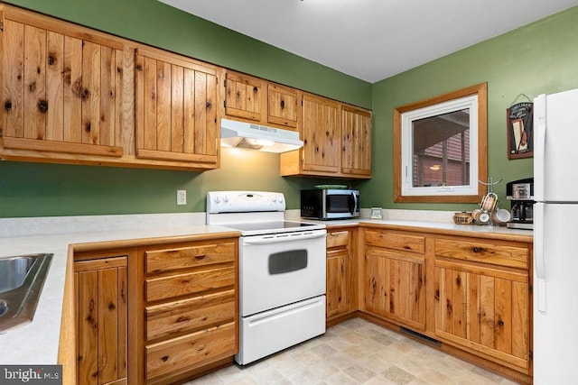 kitchen featuring sink and white appliances