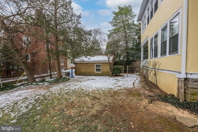 yard covered in snow with fence