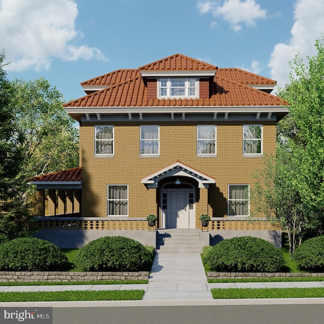 view of front facade with brick siding and a tiled roof