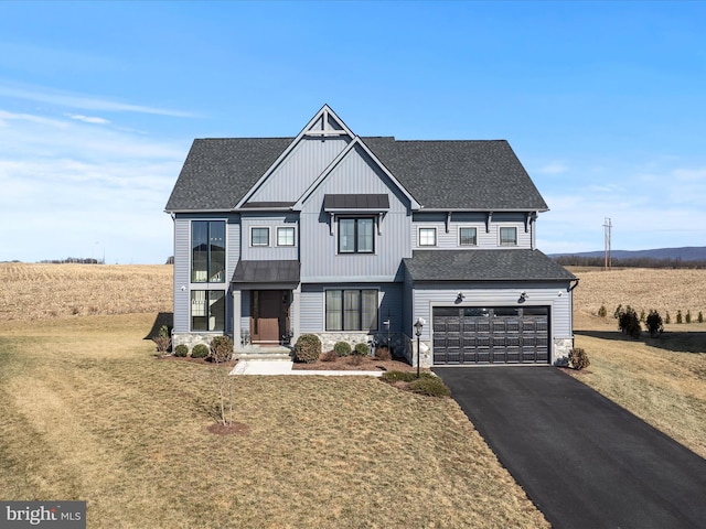 modern farmhouse style home with stone siding, aphalt driveway, roof with shingles, and an attached garage