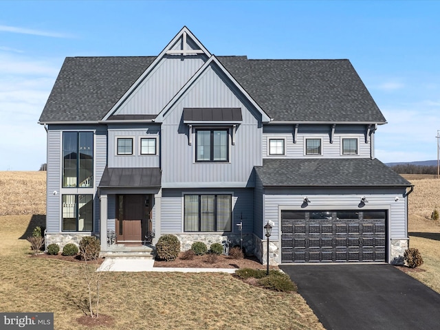 modern inspired farmhouse with driveway, a shingled roof, stone siding, an attached garage, and a standing seam roof