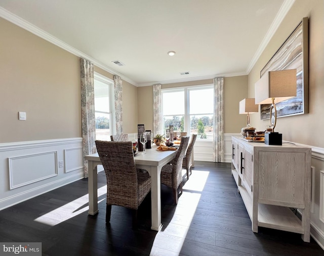 dining room with crown molding and dark hardwood / wood-style floors