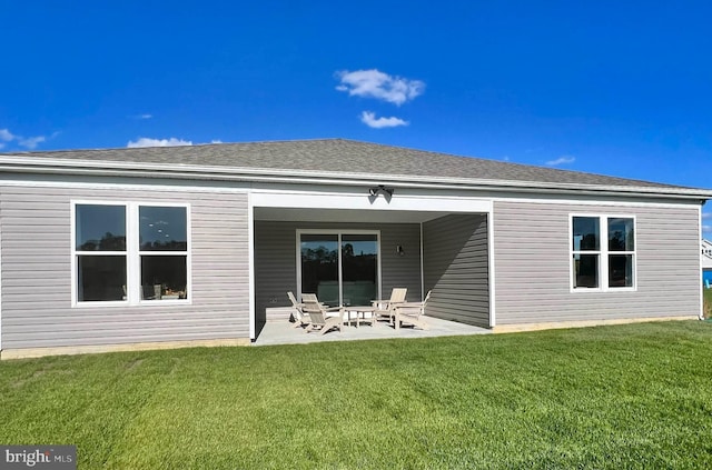 back of property featuring a patio and a lawn