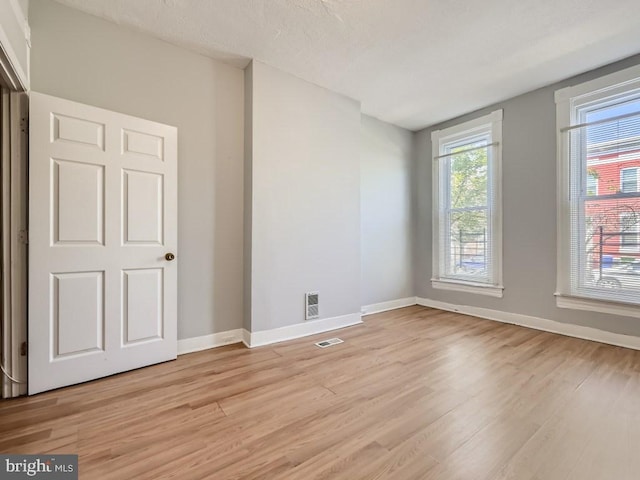 unfurnished room with light hardwood / wood-style floors