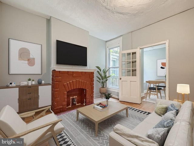 living room with wood-type flooring and a textured ceiling