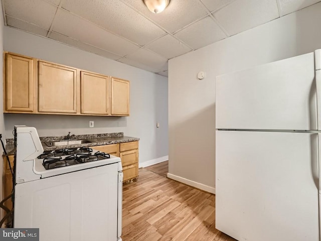 kitchen featuring a drop ceiling, white appliances, sink, light hardwood / wood-style flooring, and light brown cabinetry