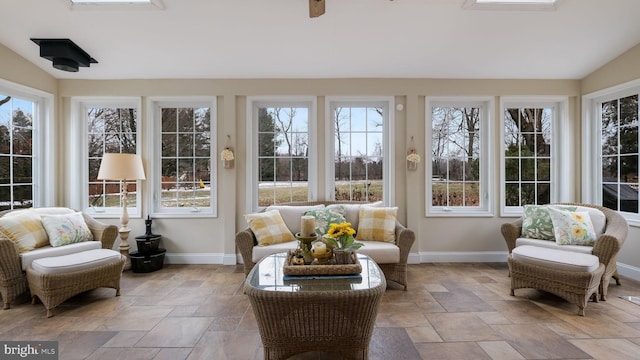 sunroom / solarium with vaulted ceiling, ceiling fan, and a wealth of natural light