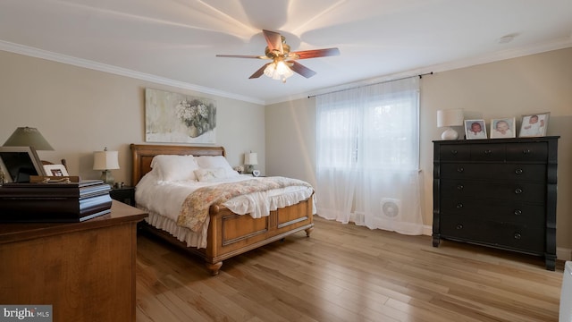 bedroom featuring ceiling fan, ornamental molding, and light hardwood / wood-style flooring