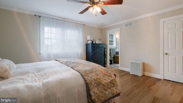 bedroom featuring ceiling fan, connected bathroom, crown molding, and light wood-type flooring