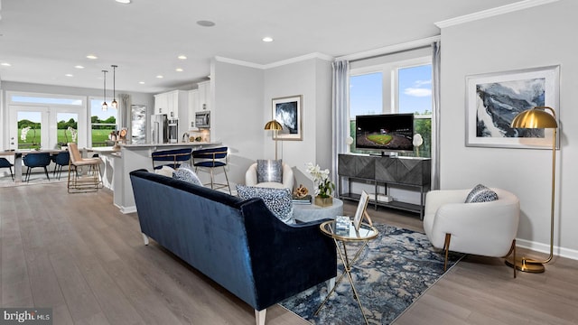 living room with light hardwood / wood-style flooring and ornamental molding