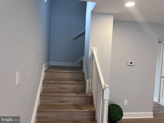 staircase with wood-type flooring