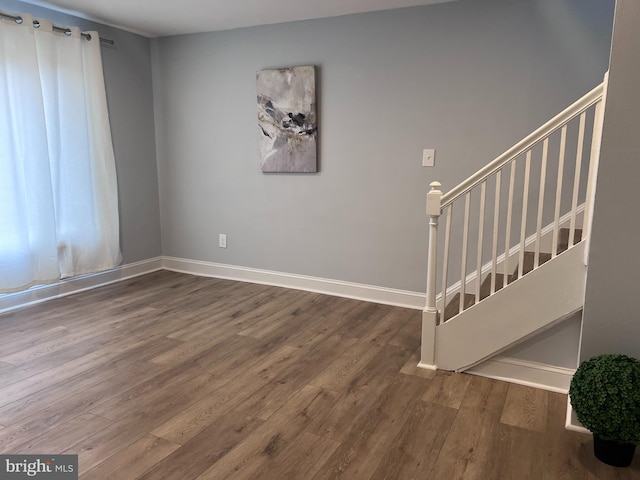 spare room featuring wood-type flooring