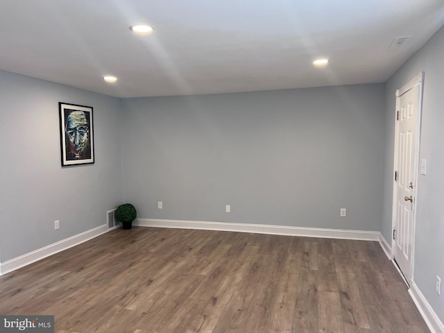 spare room with dark wood-type flooring