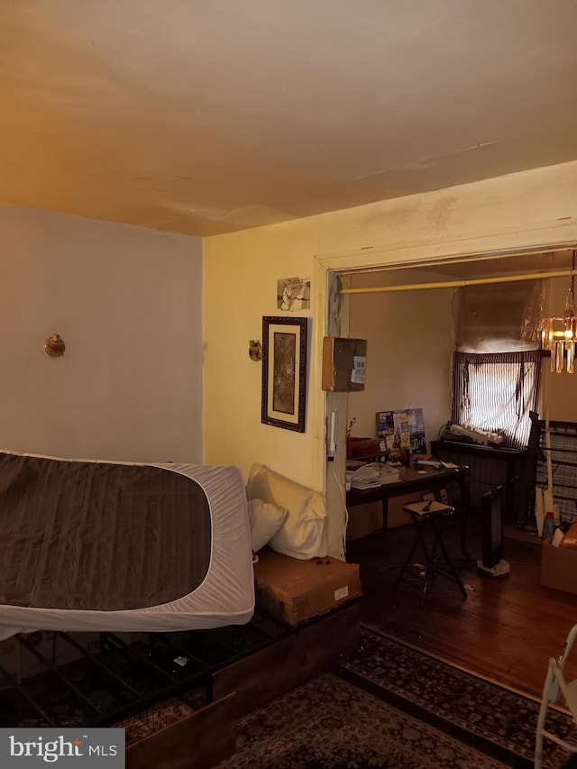 living room with hardwood / wood-style flooring and a notable chandelier