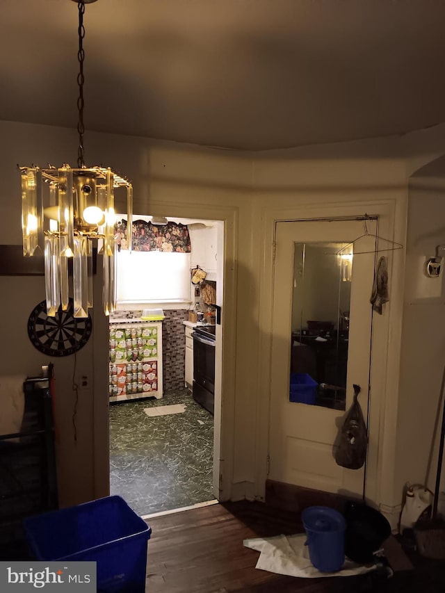 dining area featuring dark hardwood / wood-style floors and an inviting chandelier