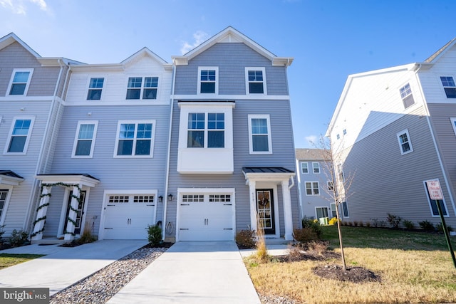 townhome / multi-family property with a front lawn and a garage