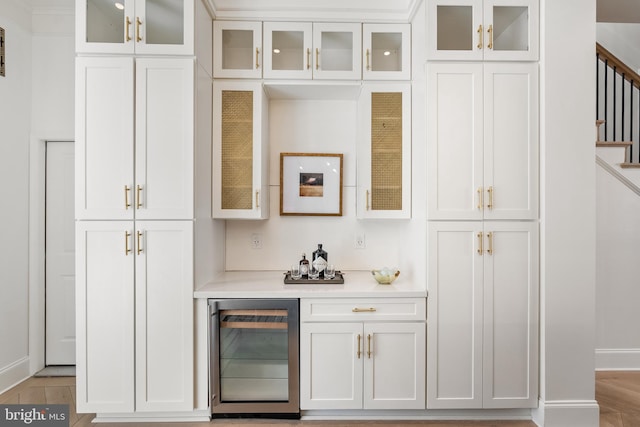 bar with beverage cooler and white cabinets