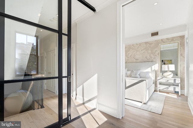 bathroom with ornamental molding and hardwood / wood-style floors