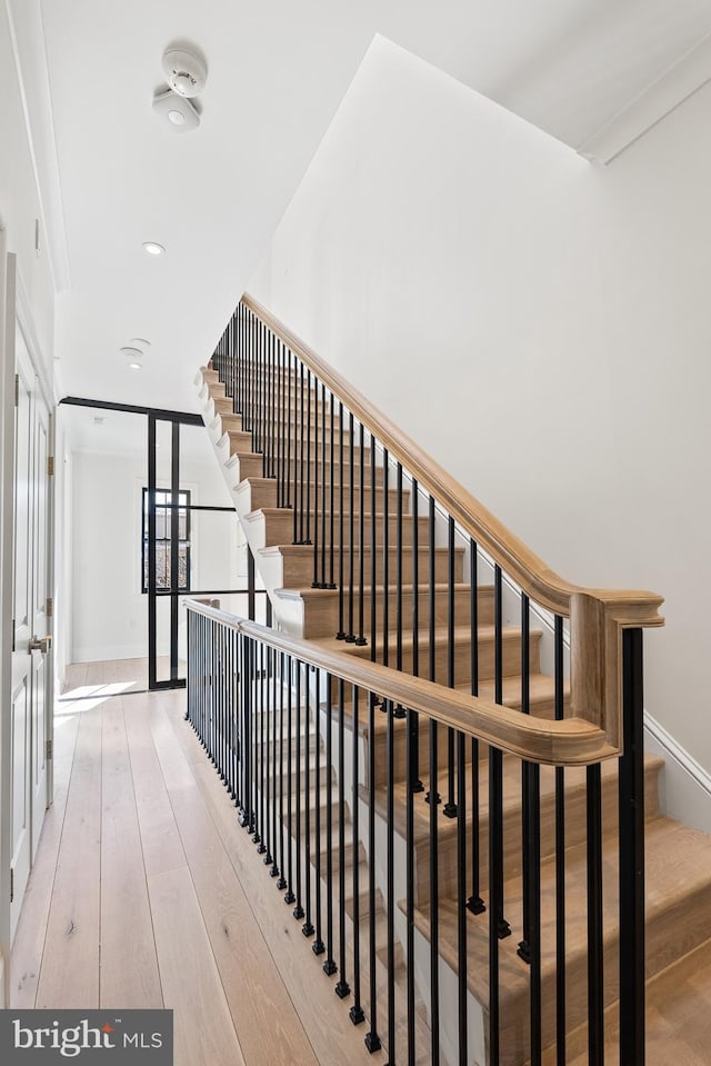 stairs featuring hardwood / wood-style floors