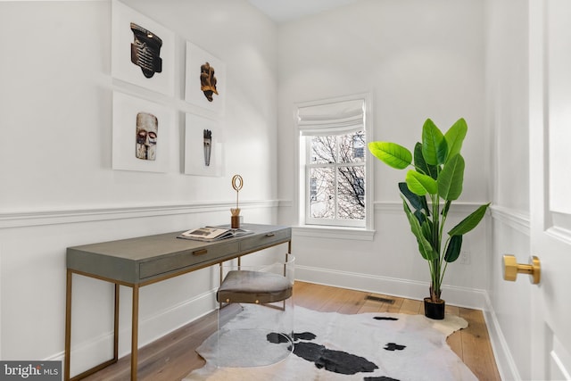 office space with wood-type flooring