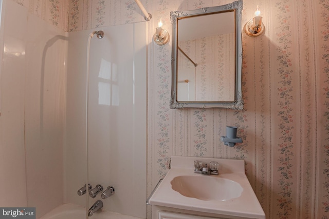 bathroom featuring vanity and  shower combination