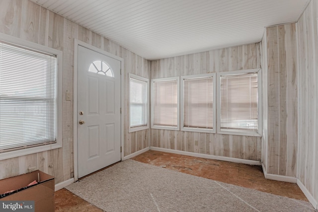 foyer with wooden walls