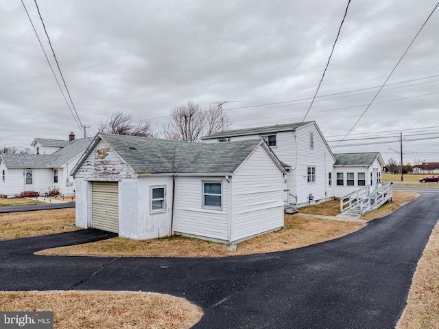 view of front of home with an outbuilding and a garage