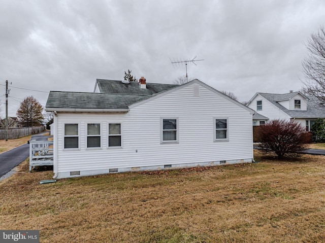 rear view of property with a lawn