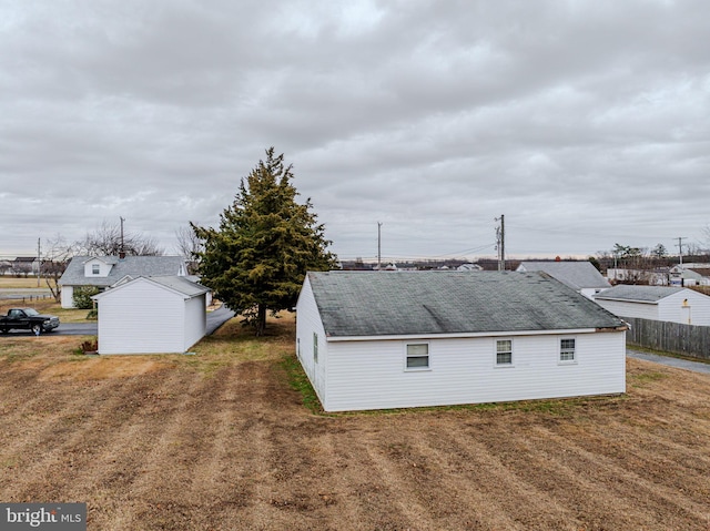 view of side of home with a yard