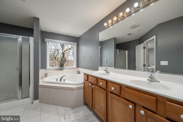 bathroom with tile patterned flooring, vanity, and independent shower and bath