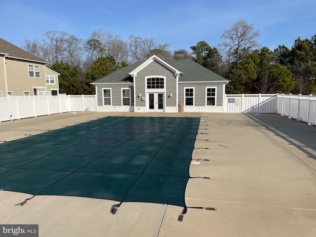 view of swimming pool with french doors and a patio area