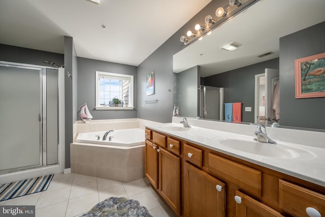 bathroom featuring plus walk in shower, vanity, and tile patterned floors