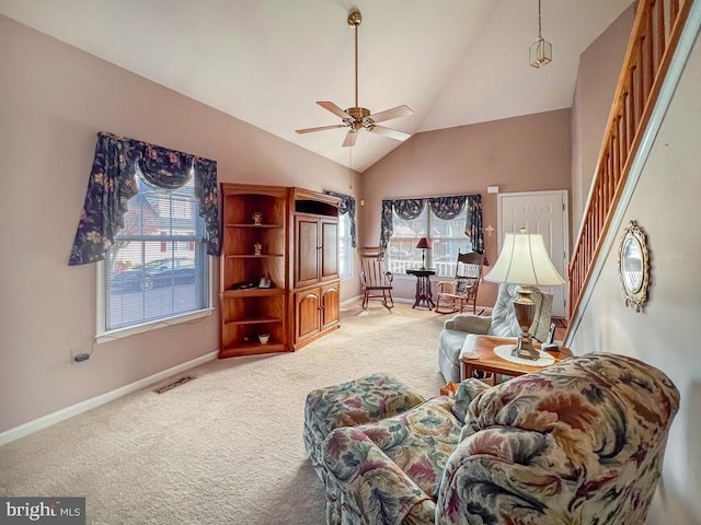 carpeted living room featuring plenty of natural light, ceiling fan, and high vaulted ceiling