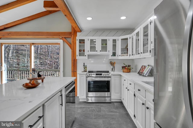 kitchen featuring light stone countertops, stainless steel appliances, beverage cooler, lofted ceiling with beams, and white cabinets