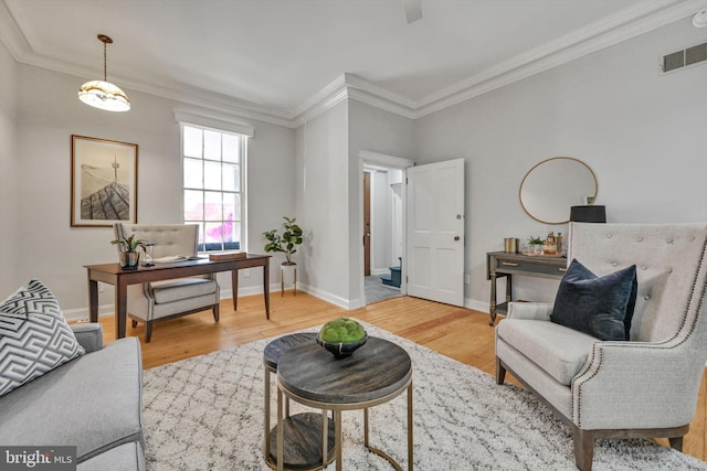 living room with hardwood / wood-style flooring and ornamental molding