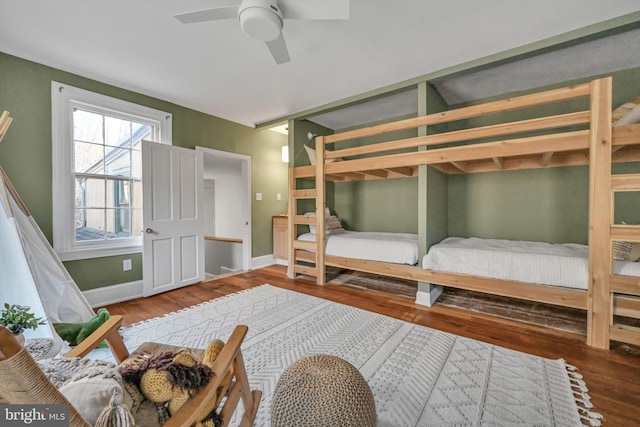 bedroom with hardwood / wood-style flooring, ceiling fan, and lofted ceiling