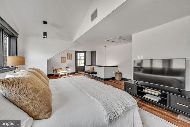 bedroom with wood-type flooring and lofted ceiling