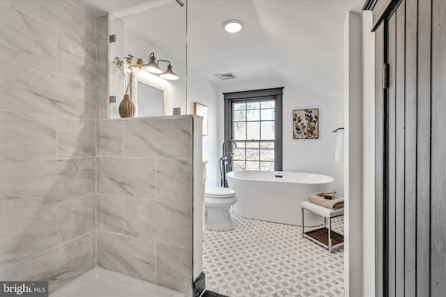 bathroom with tile patterned floors, separate shower and tub, toilet, and lofted ceiling