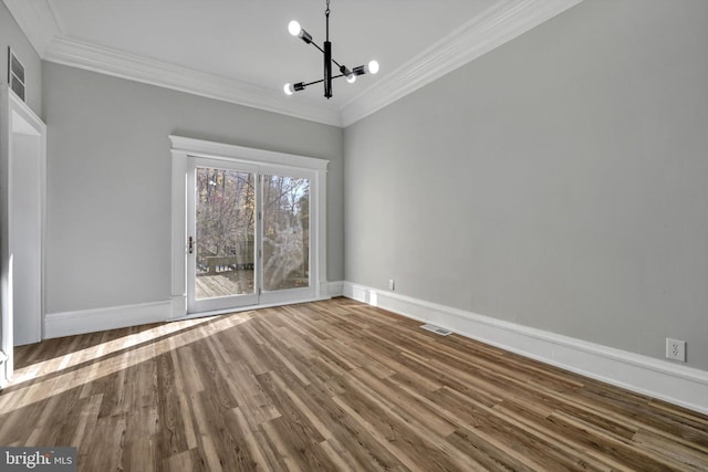 unfurnished dining area with a chandelier, ornamental molding, and hardwood / wood-style flooring