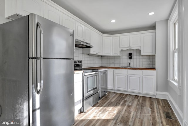 kitchen featuring white cabinetry, light hardwood / wood-style flooring, and appliances with stainless steel finishes