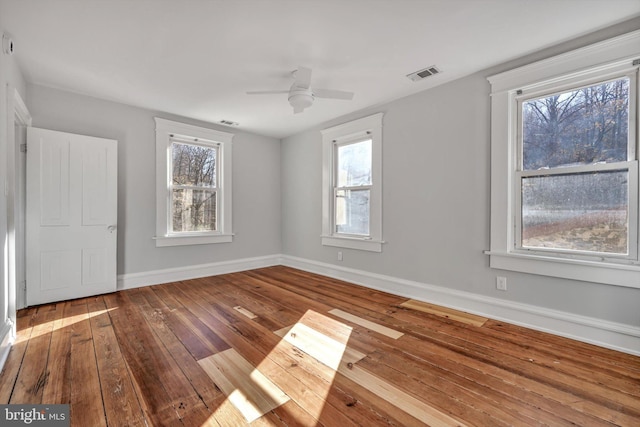 empty room with ceiling fan and hardwood / wood-style floors