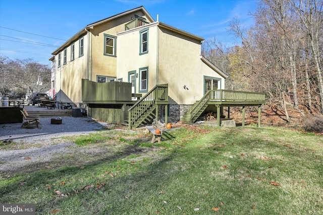 rear view of property with central AC, a deck, and a lawn