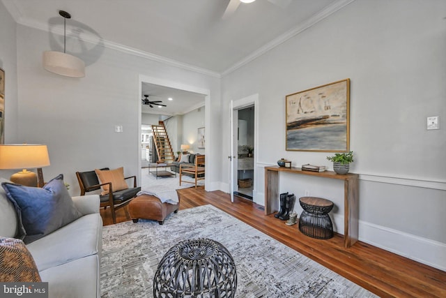 living room featuring crown molding, ceiling fan, and wood-type flooring