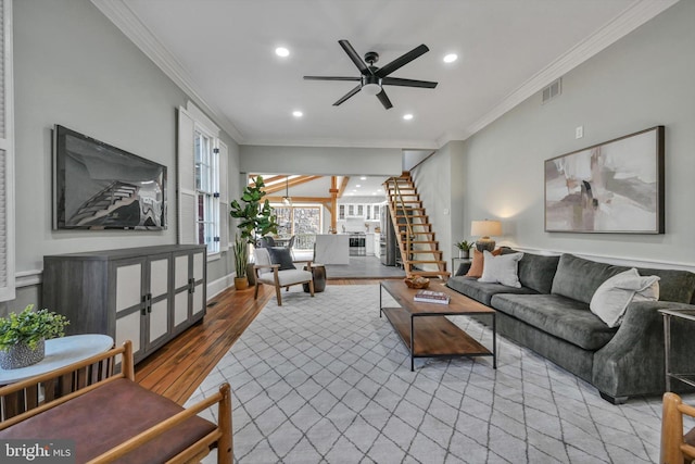 living room with light hardwood / wood-style flooring, ceiling fan, and crown molding