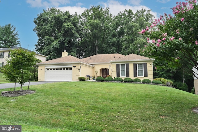 single story home featuring a front yard and a garage