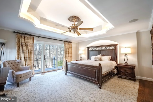 bedroom featuring access to outside, a raised ceiling, ceiling fan, and ornamental molding