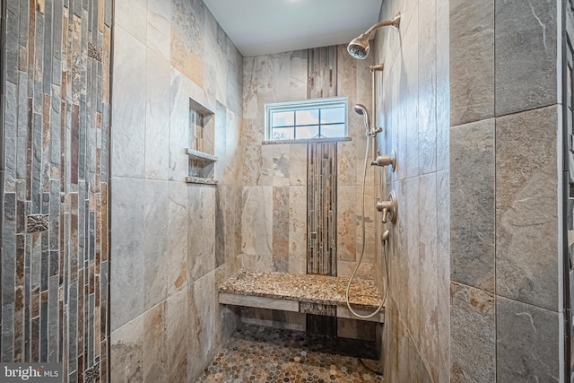 bathroom with tiled shower