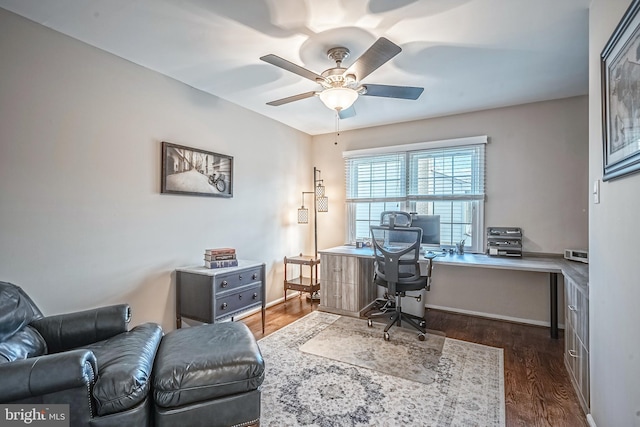 home office with dark hardwood / wood-style floors and ceiling fan